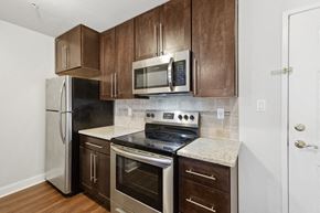 Livingston apartment for rent - a kitchen with wooden cabinets and stainless steel appliances