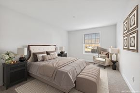 Livingston apartment for rent - a master bedroom with a large bed and a window