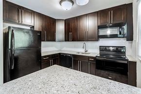 Newton apartment for rent - a kitchen with black appliances and granite counter tops