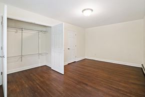 Newton apartment for rent - a bedroom with wood flooring and a closet