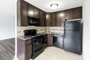 Lafayette apartment for rent - a kitchen with dark wood cabinets and stainless steel appliances