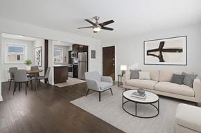 Haddonfield townhouse for rent - A modern living room with a white couch, a coffee table, and a ceiling fan.