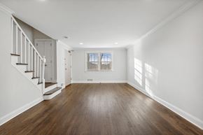 Summit apartment for rent - an empty living room with white walls and wood floors