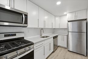 Summit apartment for rent - a white kitchen with stainless steel appliances and white cabinets