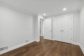 Summit apartment for rent - a bedroom with two closets and a door to a hallway