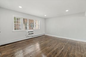 Highland Park apartment for rent - an empty living room with white walls and a window