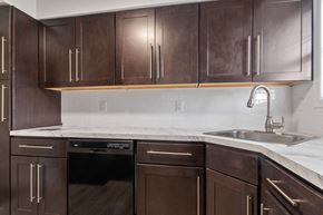 Washington apartment for rent - a kitchen with wooden cabinets and a sink