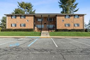 Washington apartment for rent - a large brick apartment building in a parking lot