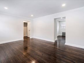 Little Falls apartment for rent - A room with wooden floors and white walls.