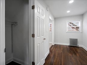 Little Falls apartment for rent - A room with a white door and a window with a view of a building outside.