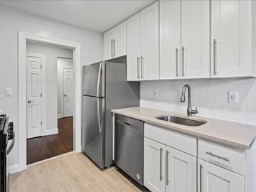 Montclair apartment for rent - a kitchen with white cabinets and a stainless steel refrigerator
