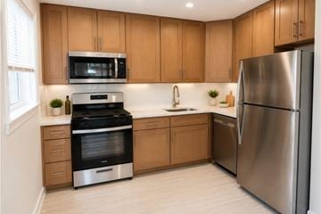 Aberdeen apartment for rent - A modern kitchen with wooden cabinets and stainless steel appliances.