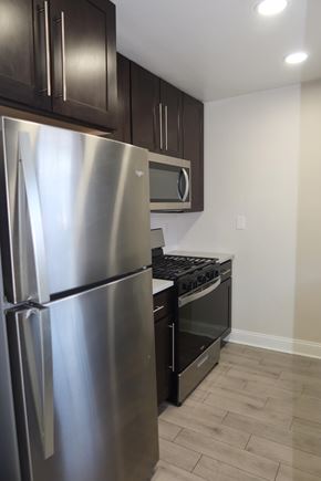 Aberdeen apartment for rent - A stainless steel refrigerator is in a kitchen with wooden cabinets.