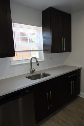 Aberdeen apartment for rent - A kitchen with black cabinets and a stainless steel dishwasher.