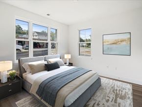 Madison apartment for rent - A bedroom with a large bed, a nightstand with a lamp, and a painting on the wall.