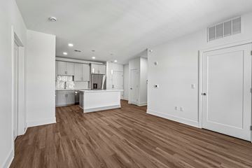 Madison apartment for rent - A kitchen with white cabinets and a wooden floor.