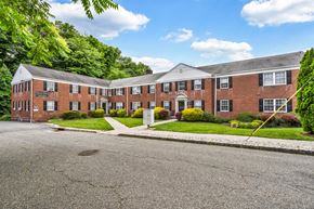 Verona apartment for rent - the front of a brick house with a driveway and grass