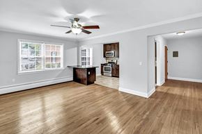 Verona apartment for rent - an empty living room with a ceiling fan and a kitchen