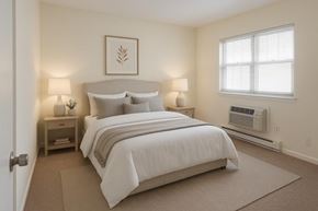 Freehold apartment for rent - A bedroom with a large bed and two lamps.