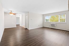 Woodbury apartment for rent - an empty living room with wood floors and a ceiling fan