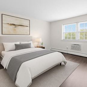 Woodbury apartment for rent - A bedroom with a large bed and a painting on the wall.
