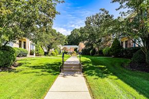 Dover apartment for rent - a sidewalk leading up to a house with trees and a gazebo