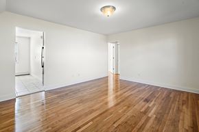 Dover apartment for rent - an empty living room with wood floors and white walls