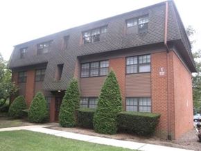 Metuchen apartment for rent - a brick apartment building with trees in front of it