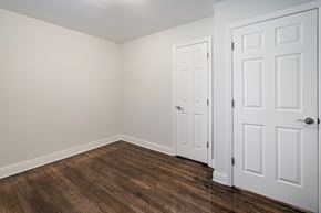 Red Bank apartment for rent - a bedroom with white walls and wood flooring and white doors
