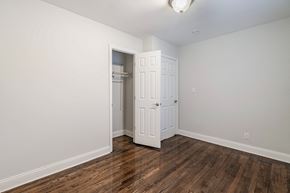 Red Bank apartment for rent - a bedroom with white walls and wood flooring and an open closet