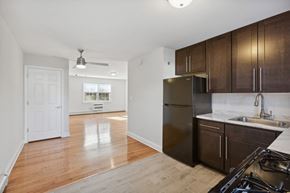 South River apartment for rent - an empty kitchen and living room with wood flooring and a stainless steel refrigerator