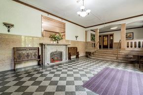 Summit apartment for rent - the lobby of a building with a fireplace and checkered floor