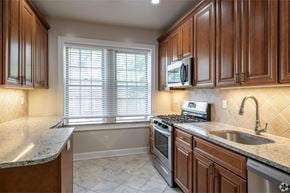Summit apartment for rent - a kitchen with a sink and a stove and a window