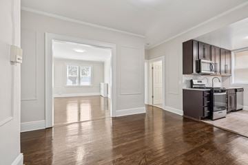 Belleville apartment for rent - A kitchen with dark wood cabinets and appliances.