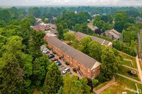 Moorestown apartment for rent - an aerial view of a brick building surrounded by trees