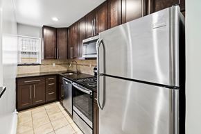 Caldwell apartment for rent - a kitchen with stainless steel appliances and wooden cabinets