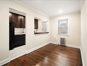 Lodi apartment for rent - A room with wooden floors and a black fridge.