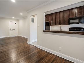 Lodi apartment for rent - A kitchen with dark wood cabinets and a white wall.