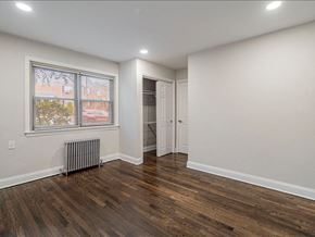 Lodi apartment for rent - A room with wooden floors and a window with a view of a building.