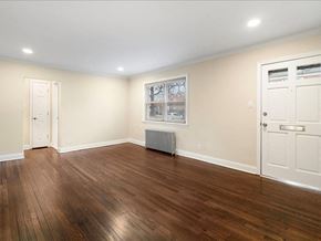 Hasbrouck Heights apartment for rent - A room with wooden floors and white walls.