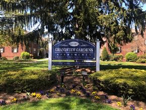 Hasbrouck Heights apartment for rent - a sign in front of a yard with flowers