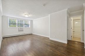 Orange apartment for rent - an empty living room with white walls and wood floors