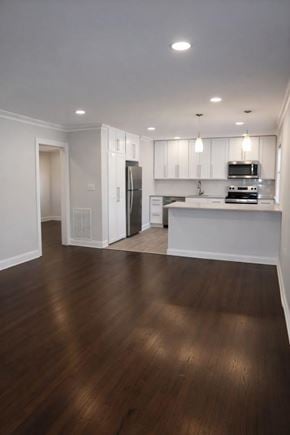 Springfield apartment for rent - A kitchen with white cabinets and a black fridge.