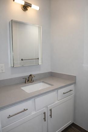 Springfield apartment for rent - A bathroom with a sink, mirror and cabinets.