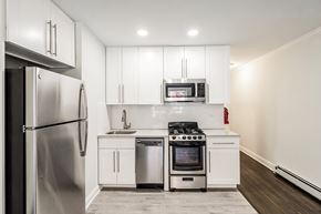 South Orange apartment for rent - a kitchen with white cabinets and stainless steel appliances