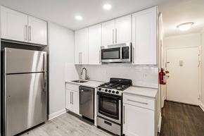 South Orange apartment for rent - a kitchen with white cabinets and stainless steel appliances