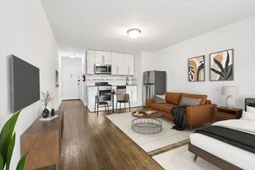 South Orange apartment for rent - A modern living room with a brown sofa and a television on the wall.