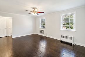 Caldwell apartment for rent - an empty living room with wood floors and a ceiling fan