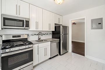 Caldwell apartment for rent - a kitchen with stainless steel appliances and white cabinets