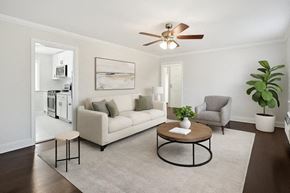 Caldwell apartment for rent - A living room with a white couch, a coffee table, and a ceiling fan.